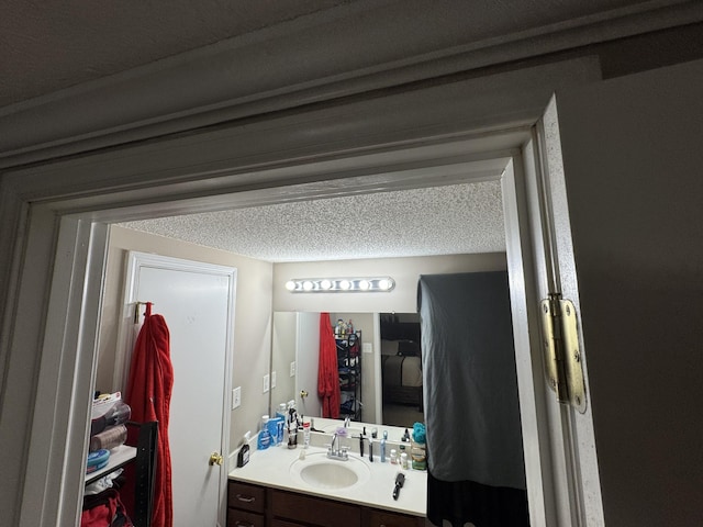 bathroom with vanity and a textured ceiling