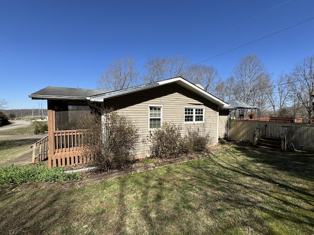 view of property exterior with a lawn