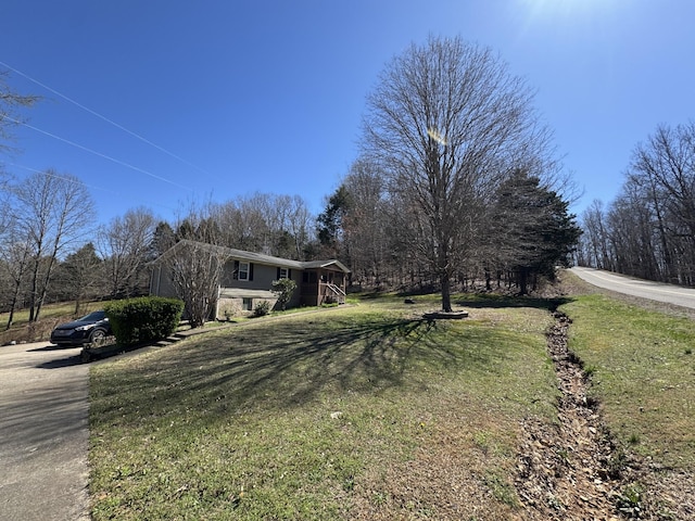 exterior space with a lawn and concrete driveway