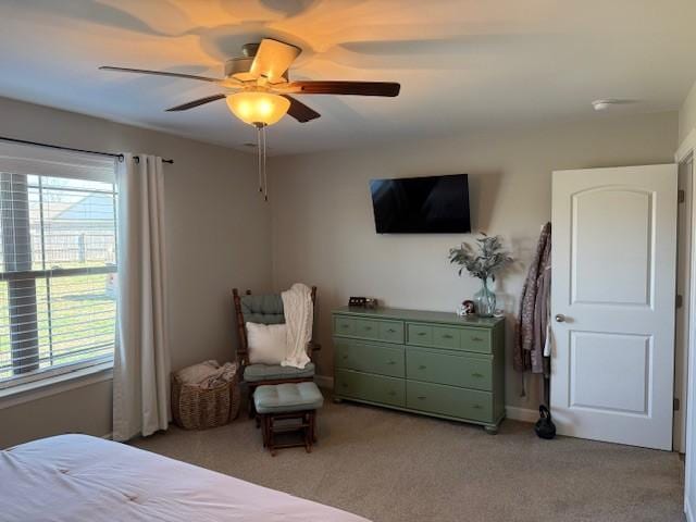 bedroom with a ceiling fan and light colored carpet