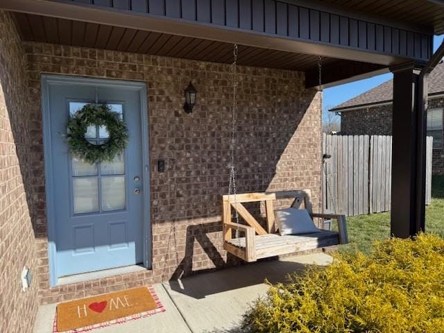 doorway to property featuring brick siding