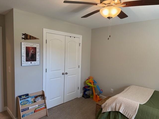 bedroom featuring carpet floors, a closet, baseboards, and a ceiling fan