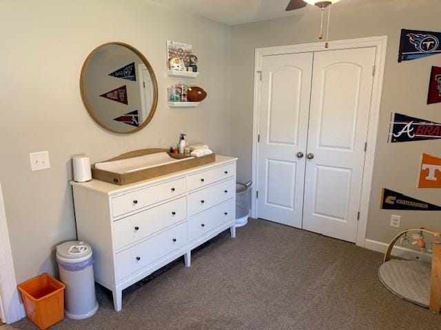 bedroom featuring a ceiling fan, dark carpet, and a closet