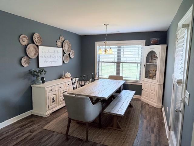 dining area featuring dark wood-style flooring and baseboards