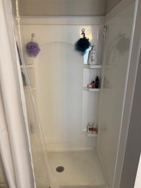 full bath featuring a shower stall