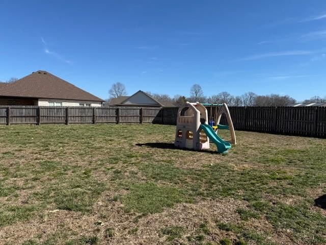 view of playground with a yard and a fenced backyard