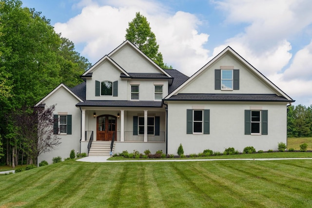 view of front of home featuring a front lawn, a porch, and stucco siding