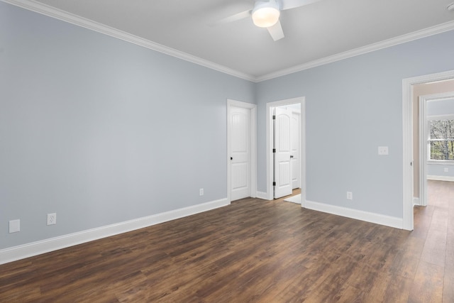 unfurnished room with baseboards, ceiling fan, dark wood finished floors, and crown molding