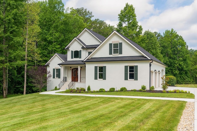 view of front of home with a front lawn, stucco siding, an attached garage, and a shingled roof