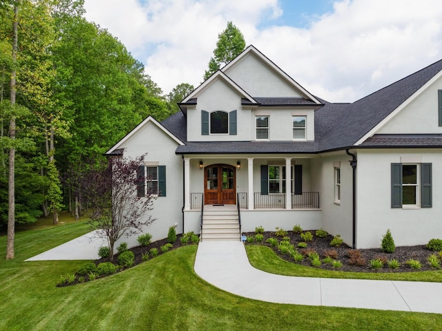 view of front of house featuring a front lawn, covered porch, french doors, and stucco siding