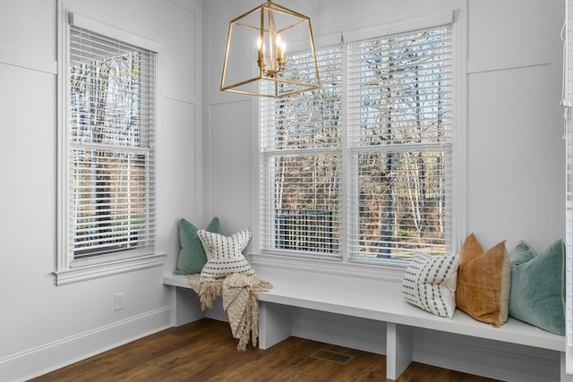 sitting room featuring dark wood-style flooring, a healthy amount of sunlight, visible vents, and baseboards