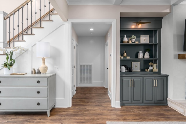 interior space with dark wood-style flooring, visible vents, and baseboards