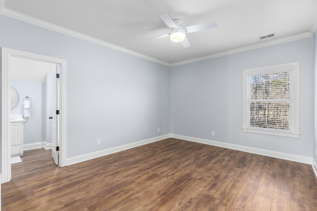 empty room featuring dark wood finished floors, visible vents, ornamental molding, ceiling fan, and baseboards