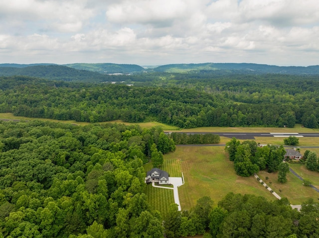 aerial view with a wooded view and a mountain view