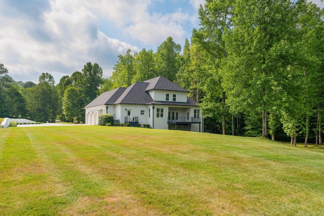 back of house with a yard and an attached garage