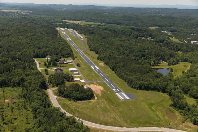 drone / aerial view with a water view and a wooded view