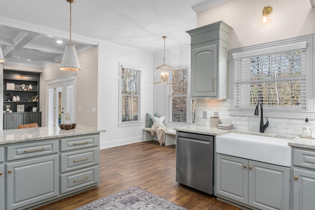 kitchen with stainless steel dishwasher, a sink, decorative light fixtures, and gray cabinetry