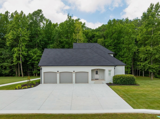 view of front of home featuring a shingled roof, driveway, a front lawn, and stucco siding