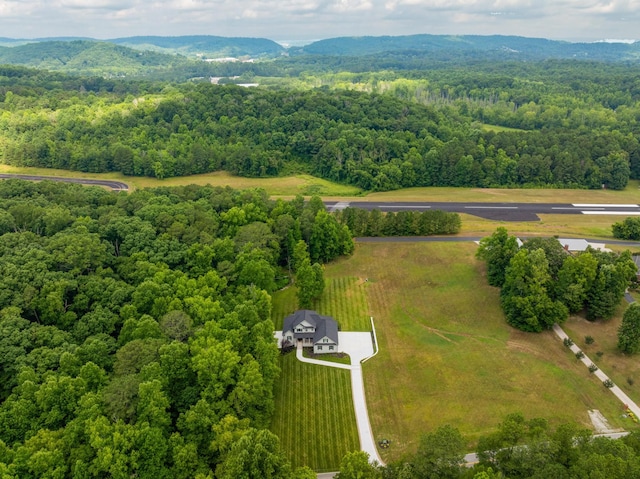 drone / aerial view featuring a mountain view and a forest view