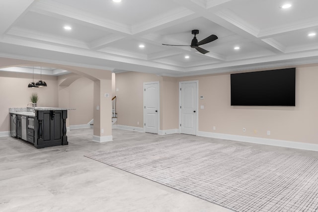 below grade area featuring arched walkways, recessed lighting, a sink, a ceiling fan, and baseboards