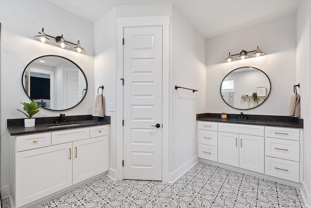 bathroom with two vanities, a sink, and tile patterned floors