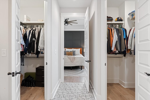 spacious closet featuring light wood finished floors and ceiling fan