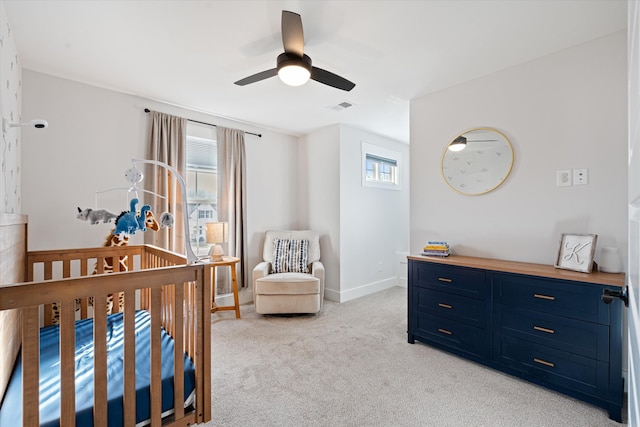 bedroom with baseboards, visible vents, a ceiling fan, and light colored carpet