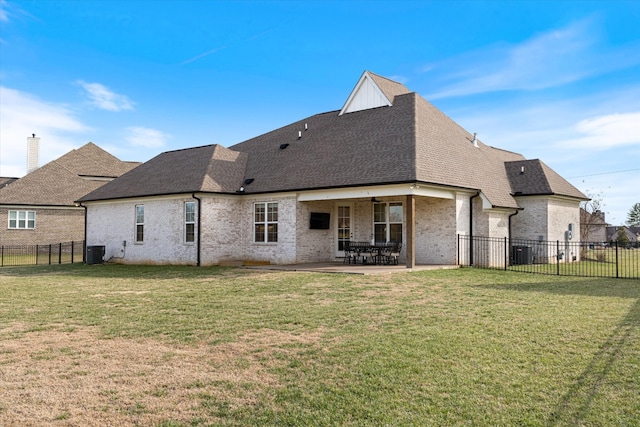 back of property featuring a patio, a yard, central AC, and roof with shingles