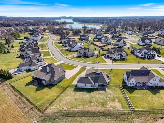 birds eye view of property with a water view and a residential view