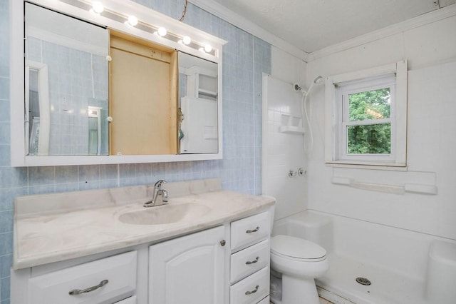 full bath featuring tile walls, toilet, ornamental molding, vanity, and a shower stall