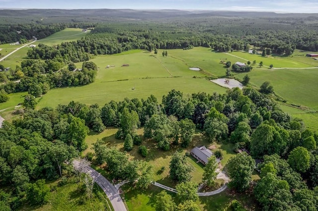 birds eye view of property featuring a forest view