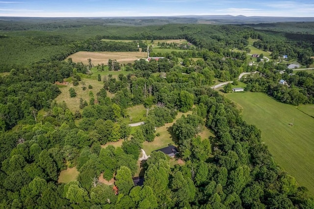 birds eye view of property with a forest view