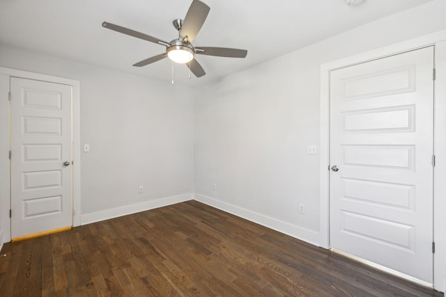 unfurnished room featuring dark wood-type flooring, baseboards, and a ceiling fan