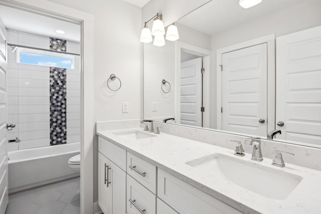 bathroom with marble finish floor, a sink, toilet, and double vanity