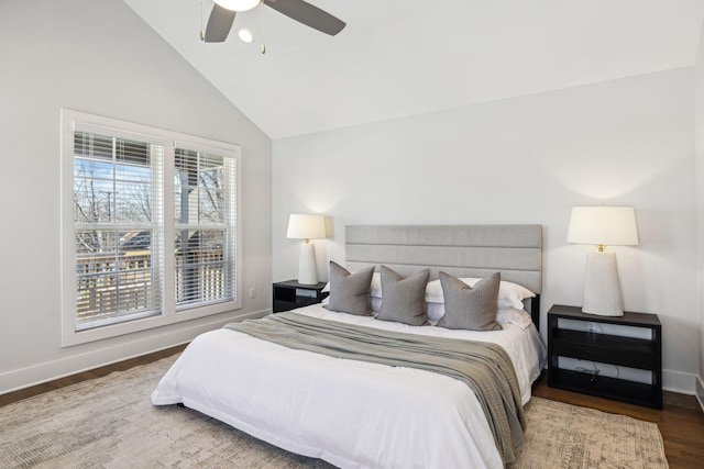 bedroom with vaulted ceiling, ceiling fan, wood finished floors, and baseboards