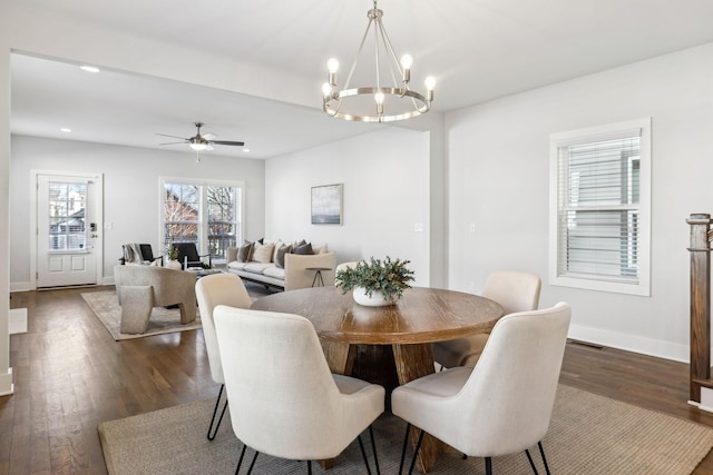 dining space featuring recessed lighting, visible vents, dark wood-type flooring, baseboards, and ceiling fan with notable chandelier