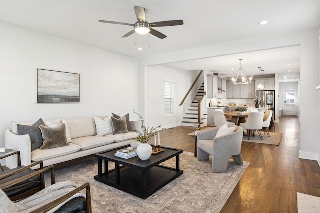 living area with recessed lighting, stairway, baseboards, and wood finished floors