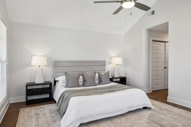 bedroom featuring lofted ceiling, wood finished floors, visible vents, and baseboards