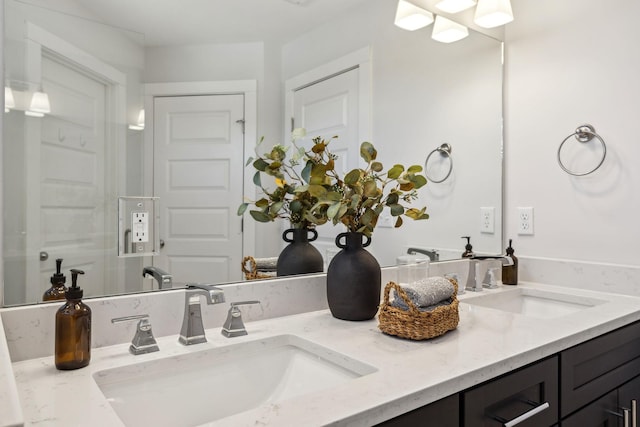 bathroom featuring a sink and double vanity