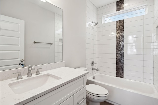 bathroom featuring toilet, vanity, and shower / bathtub combination