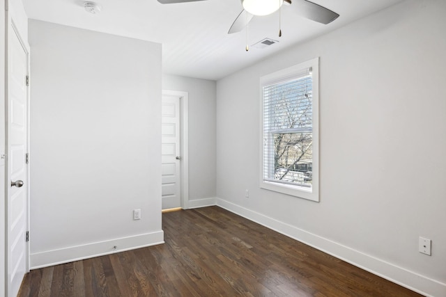 unfurnished bedroom with ceiling fan, baseboards, visible vents, and dark wood finished floors