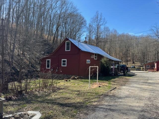 view of home's exterior featuring driveway and a barn