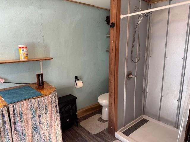 full bath with toilet, a shower, and wood finished floors