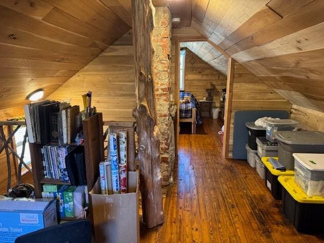 interior space with lofted ceiling, wood ceiling, wooden walls, and dark wood finished floors