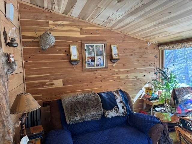 living room with lofted ceiling, wood walls, and wood ceiling