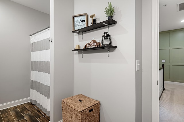 interior details featuring baseboards, visible vents, and wood tiled floor