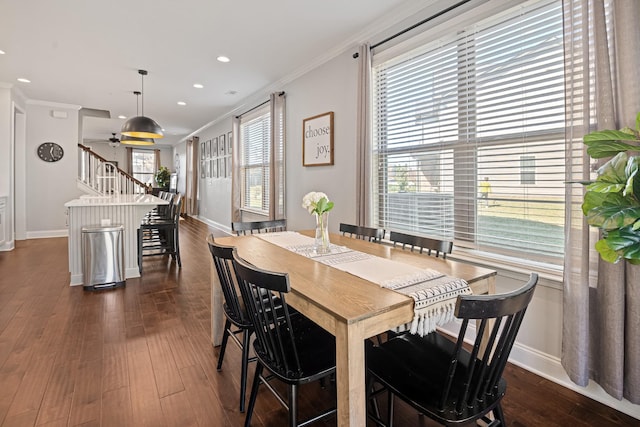 dining room featuring dark wood-style floors, baseboards, ornamental molding, and recessed lighting