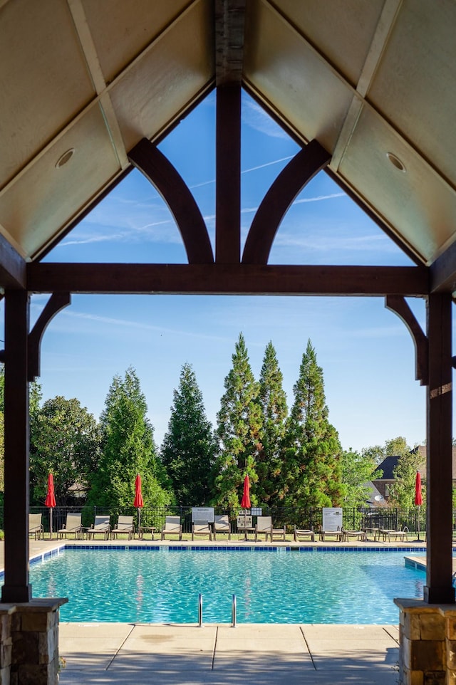 pool featuring fence and a patio