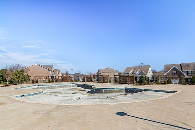 pool with a residential view and fence