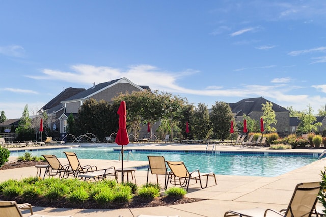 view of pool with a patio area and fence